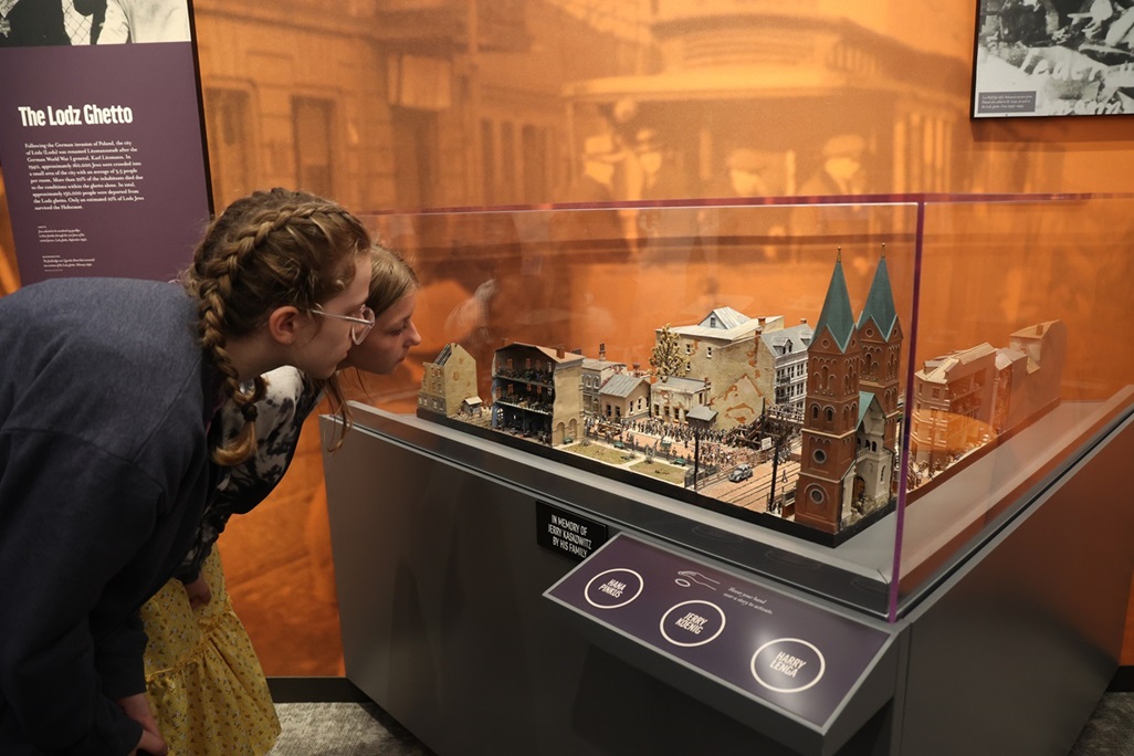 Two girls looking at Lodz Ghetto model